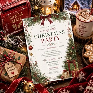 May include: A rectangular Christmas party invitation card featuring a dark red bow at the top, green pine branches, red berries, and gold ornaments. The text reads: Please join us for a very little Christmas party, Saturday, December 18, 6:00 PM.
