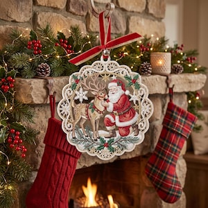 May include: A round, lace-edged Christmas ornament featuring a detailed illustration of Santa Claus kneeling beside a reindeer. The ornament is suspended by a red velvet ribbon and displays a festive scene with snowflakes and holly accents.