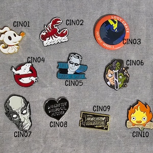Enamel Needle Minder - Cinema/TV theme - assorted sizes