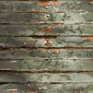 May include: Close-up of a weathered wooden surface with peeling green paint. The wood is arranged in horizontal planks, creating a rustic and textured background.