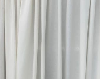 May include: White sheer curtains with vertical folds, creating a smooth and elegant texture.