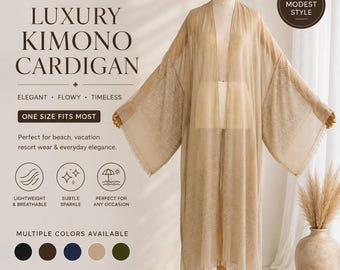 May include: A beige kimono cardigan featuring an open front, wide sleeves, and a subtle shimmering texture throughout the fabric. The garment is displayed on a mannequin and includes text on the left side reading LUXURY KIMONO CARDIGAN.