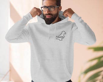 May include: A light gray hooded sweatshirt featuring a black outline map of Pakistan with the word PAKISTAN printed inside the map on the left chest area. The hoodie includes a front kangaroo pocket and matching drawstrings at the neckline.