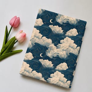 May include: A rectangular fabric piece featuring a dark blue sky pattern with swirling lines, white fluffy clouds, small stars, and crescent moons, accompanied by two pink tulips with green stems and leaves on the side.