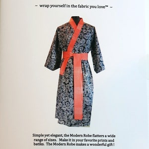 May include: A black and white floral robe with a red sash. The text "Modern Robe" and "~ wrap yourself in the fabric you love™ ~" is printed on the page. The text "The Modern Robe™" is also printed on the page.