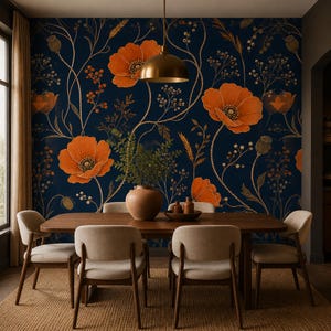 May include: A dining room featuring a dark blue wallpaper with a pattern of orange poppies and golden stems. A wooden dining table with four light-colored chairs sits in front of the wall, with a round vase and a brass pendant light above.