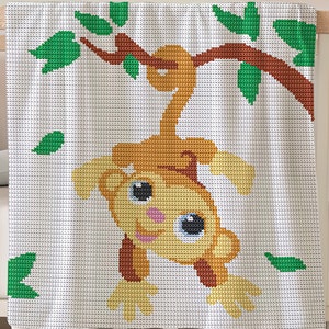 May include: A white crocheted baby blanket with a brown monkey hanging from a green tree branch. The monkey has big blue eyes and a pink nose.