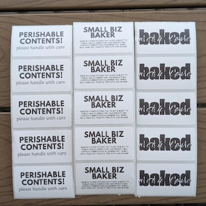 May include: A sheet of fifteen rectangular white adhesive labels arranged in three columns. The labels feature black text reading PERISHABLE CONTENTS! please handle with care, SMALL BIZ BAKER with allergen warnings, and baked with love.