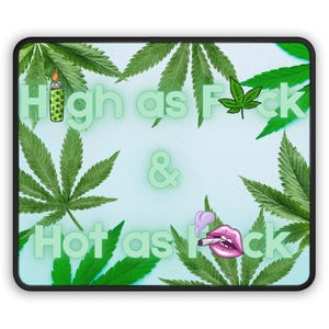 May include: A rectangular mouse pad with a light blue background featuring green cannabis leaf illustrations. The text reads High as F*ck & Hot as F*ck in light green letters, accompanied by a lighter icon, a single leaf, and pink lips.