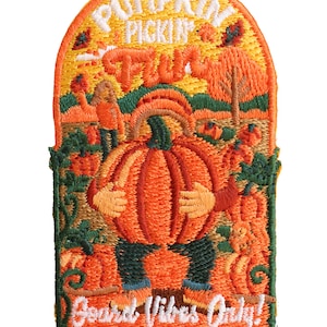 May include: An embroidered patch with an arched top featuring a central figure holding a large orange pumpkin. The text reads PUMPKIN PICKIN' FUN at the top and Gourd Vibes Only! at the bottom. The design includes green vines, trees, and foliage.