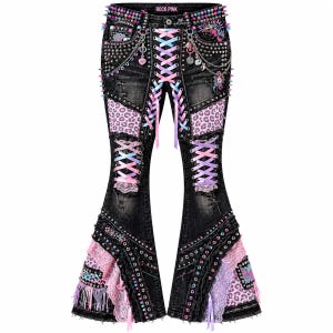 May include: Black denim flare pants featuring a front lace-up closure with pastel ribbons, pink leopard print panels, lace trim, silver studs, and metal chains. The waistband displays the text ROCK PINK with colorful spikes and decorative charms.
