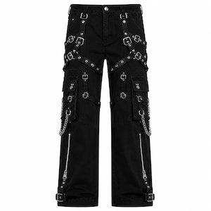 May include: Black cargo pants featuring multiple straps, silver-toned metal buckles, and eyelets. The pants include large side pockets, decorative silver chains attached to the pockets, and vertical zippers at the lower legs with adjustable buckle straps.