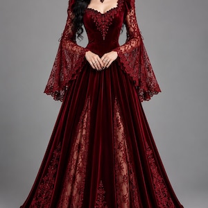May include: A floor-length deep red velvet gown featuring long bell sleeves with intricate lace detailing, a sweetheart neckline, and a bodice adorned with matching lace embroidery. The skirt includes vertical lace panels and a full hemline.