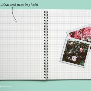 May include: An open notebook with a grid pattern on the pages. Two instant photos of pink flowers are stuck to the right page. The text "sketch ideas and stick in photos" is written at the top of the page.