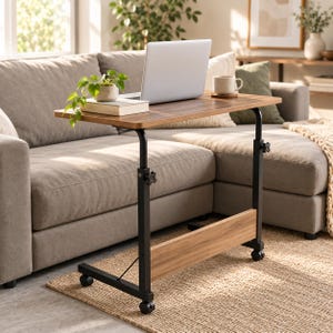 May include: A mobile laptop desk with a rectangular wood-grain surface and a black metal frame. The desk features adjustable height knobs on the side supports, a lower horizontal wood-grain support panel, and four small caster wheels at the base.