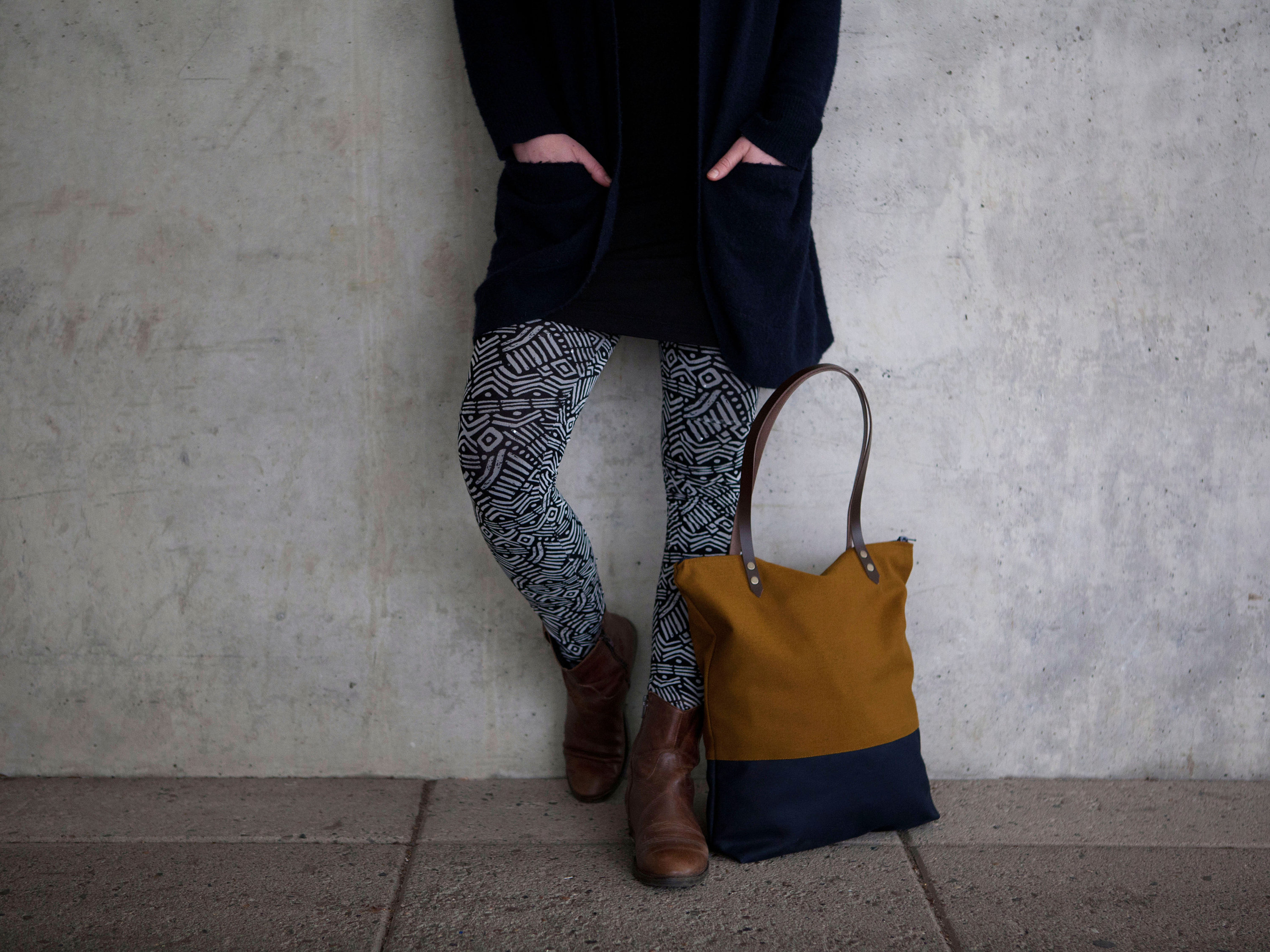 Blue tote bag with brown shop handles