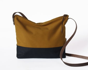 Small fabric shoulder bag with leather strap, practical handbag with zip and inside pockets