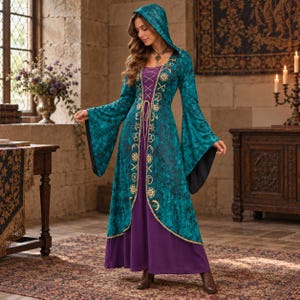 May include: A floor-length hooded dress featuring a deep purple base layer and a teal, mottled-pattern overcoat with long, flared sleeves. The overcoat is adorned with gold-colored celestial symbols and a lace-up front closure at the bodice.