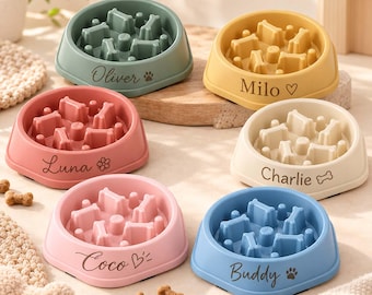 May include: Six round, colorful slow-feeder pet bowls with internal dividers. The bowls are sage green labeled Oliver, yellow labeled Milo, dusty rose labeled Luna, cream labeled Charlie, light pink labeled Coco, and blue labeled Buddy.