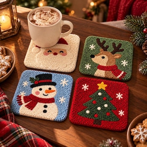 May include: A set of four square punch needle coasters featuring holiday designs: a cream-coloured Santa Claus, a green reindeer with a red scarf, a blue snowman with a black hat and red scarf, and a red Christmas tree with a yellow star.