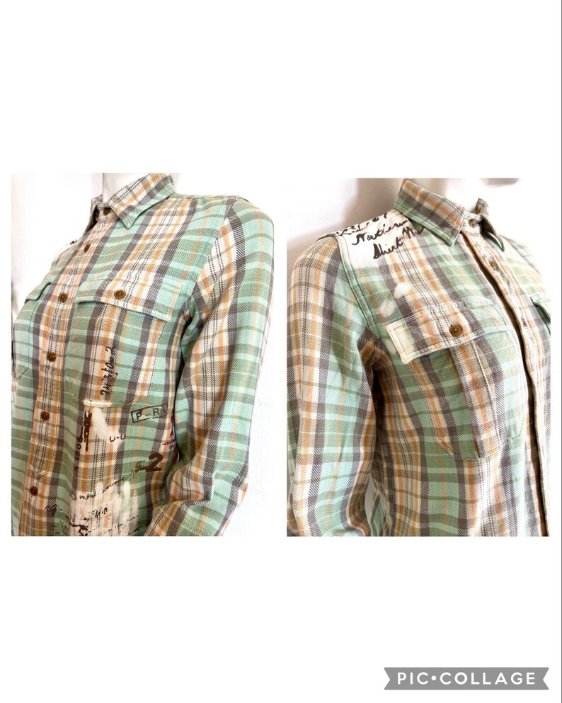 May include: A long-sleeved plaid shirt in shades of green, brown, and white. The shirt features two chest pockets and button closures. Handwritten text and numbers are visible on the front and shoulder of the shirt.