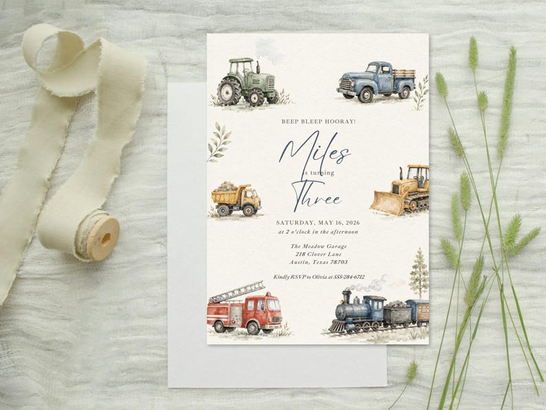 May include: A rectangular invitation card featuring watercolor illustrations of a green tractor, blue pickup truck, yellow dump truck, bulldozer, red fire engine, and a steam train. The text reads BEEP BLEEP HOORAY! Miles is turning Three.