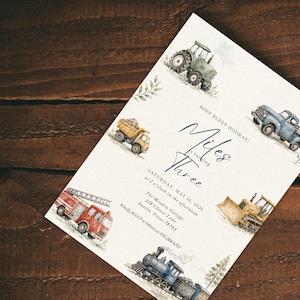 May include: A white rectangular invitation card featuring watercolor illustrations of a green tractor, yellow dump truck, blue pickup truck, red fire engine, yellow bulldozer, and a blue steam train, with text reading BEEP BLEEP HOORAY! Miles is turning Three.