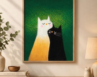May include: A framed wall art print featuring a white and orange cat standing next to a black cat against a textured dark green background. Both cats have closed eyes, small orange noses, and pink cheeks, depicted in a soft, grainy illustration style.