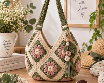 May include: A crochet handbag featuring a granny square pattern with cream, sage green, and dusty pink floral motifs. The bag has a single sage green handle attached with gold-tone rings and a decorative tassel charm with small flowers and leaves.