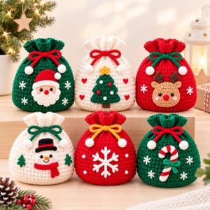 Könnte beinhalten: Sechs kleine, runde, gehäkelte Beutel mit Kordelzug und weihnachtlichen Motiven. Die Beutel sind mit Applikationen von Weihnachtsmann, Weihnachtsbaum, Rentier, Schneemann, einer weißen Schneeflocke und einer Zuckerstange in Rot, Grün und Weiß verziert.