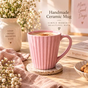 May include: A light pink ceramic mug with a vertical ribbed texture and a curved handle. The mug is filled with a beverage topped with cinnamon. Text on the image reads: Handmade Ceramic Mug, SIMPLE MOMENTS BEAUTIFUL DAYS, and a heart symbol.