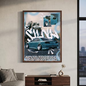 May include: A framed poster featuring a teal Nissan Silvia car in a drift stance. The design includes large white graffiti-style text reading "SILVIA," smaller "NISSAN" text, two inset photos of the car, and white arrows on a blurred background.