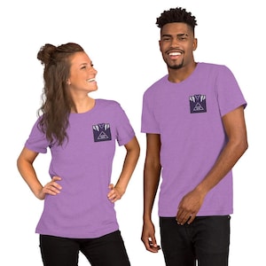 May include: A heathered lavender short-sleeve t-shirt featuring a small rectangular graphic on the left chest. The graphic displays a stylized dark purple jersey icon with white accents and the text "ALPHINA WISH" inside a white triangle.