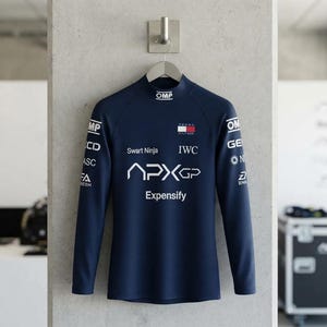 May include: A dark blue long-sleeve mock neck shirt featuring white sponsor logos including OMP, Tommy Hilfiger, IWC, Swart Ninja, APXGP, and Expensify. The shirt has a fitted silhouette with branding printed on the chest and down both sleeves.