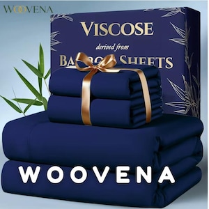 May include: A set of deep navy blue viscose sheets derived from bamboo, presented in a matching dark blue box with gold text reading WOOVENA, VISCOSE, derived from BAMBOO SHEETS. The folded fabric is tied with a gold ribbon and a bow.
