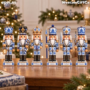 May include: Six decorative nutcracker figurines featuring blue and white porcelain-style patterns. Each nutcracker stands on a rectangular base with a nameplate reading Oliver, Henry, William, James, Arthur, or Charles. Text reads 2D FLAT and WeecomGiftCo.
