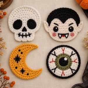 May include: Four crocheted coasters featuring Halloween themes: a white skull with black details, a vampire face with black hair and fangs, a yellow crescent moon with black stars, and a round eyeball with a green iris and red veins.