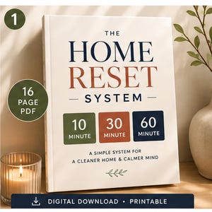 May include: A 16-page PDF digital download titled The Home Reset System. The cover features dark blue and rust-colored text, with three colored squares labeled 10, 30, and 60 minute. It includes the subtitle A Simple System for a Cleaner Home & Calmer Mind.