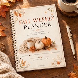 May include: A spiral-bound Fall Weekly Planner with a cream cover featuring autumn leaf illustrations, a mug, and pumpkins. The text reads Fall Weekly Planner, For everyday autumn life, and includes sections for weekly spreads, meal planning, and habit trackers.