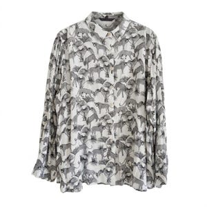 May include: A long-sleeved button-down shirt in white featuring a repeating black graphic print of leopards and palm trees. The shirt has a standard collar, a full-length front button placket, and cuffed sleeves with a relaxed, flowing fit.