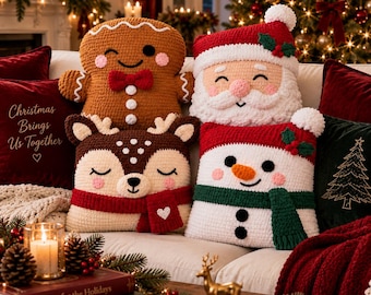 May include: Four crochet pillows featuring holiday characters: a brown gingerbread person with a red bow tie, a Santa Claus with a white beard and red hat, a brown deer with a red scarf, and a white snowman with a green scarf and orange nose.