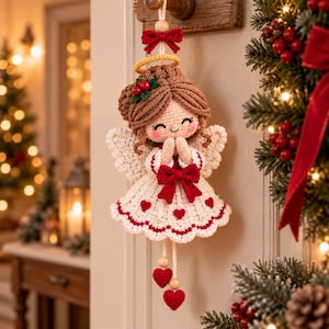 May include: A crocheted angel ornament with brown yarn hair, a yellow halo, and white wings. The angel wears a white dress with red heart accents, a red bow at the waist, and a red bow at the top. Two red crocheted hearts hang from the bottom.