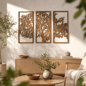 Puede incluir: Un conjunto de tres paneles de pared rectangulares de madera con intrincados diseños de ramas de árbol cortados con láser. Cada panel está enmarcado en madera y muestra un patrón detallado e interconectado de ramas y hojas.