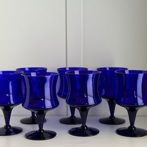 May include: Set of six cobalt blue glass wine glasses with a flared bowl and a stem.