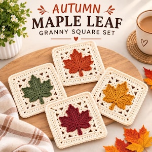 May include: Four square crochet coasters featuring cream-colored borders and central maple leaf motifs in orange, green, yellow, and dark red. The text AUTUMN MAPLE LEAF GRANNY SQUARE SET is displayed above the coasters on a wooden surface.