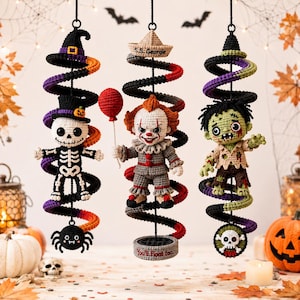 May include: Three hanging crochet ornaments featuring a skeleton in a witch hat, a clown holding a red balloon with a paper boat labeled S.S. Georgie, and a green zombie. Each figure is attached to a black spiral base with themed accents.