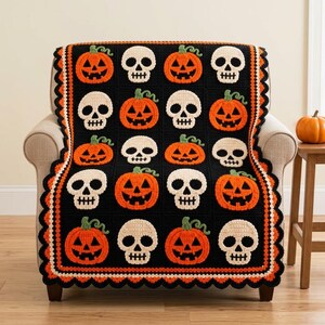 Puede incluir: Una manta de ganchillo negra con un patrón de cuadrícula repetitivo de calabazas de Halloween naranjas y calaveras de color blanco roto. La manta está rematada con un borde festoneado decorativo en capas alternas de hilo negro, naranja y blanco.