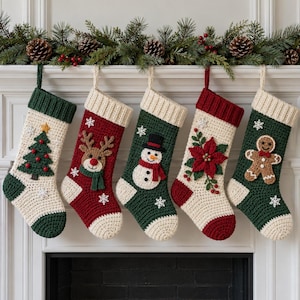 Puede incluir: Cinco calcetines navideños de ganchillo colgados en fila. Cada calcetín presenta un aplique festivo único: un árbol de Navidad, un reno, un muñeco de nieve, una flor de Pascua y un hombre de jengibre, con pequeños copos de nieve.