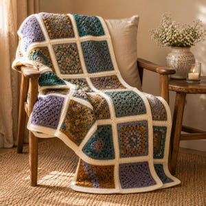 May include: A crochet blanket featuring a grid of square motifs in shades of mustard yellow, sage green, lavender, and deep purple, all joined by a cream-colored border. The textile displays intricate yarn patterns and a textured, handmade appearance.