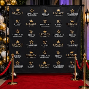 May include: A black step and repeat backdrop featuring a repeating gold logo pattern for Legacy Events, Starlight Entertainment, and Rising Vision. The banner is supported by a metal frame and is positioned behind a red carpet with gold stanchions.